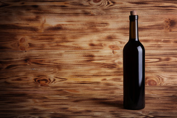 Wine bottle with cork on wooden background