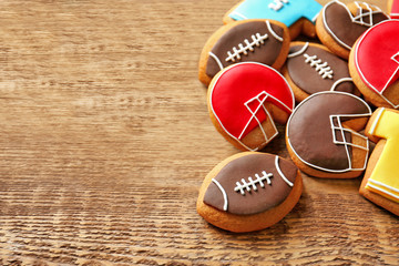 Obraz na płótnie Canvas Creative cookies decorated in football style on wooden background