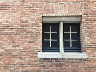 Fototapeta na wymiar Brown brick block wall background texture with windows background texture