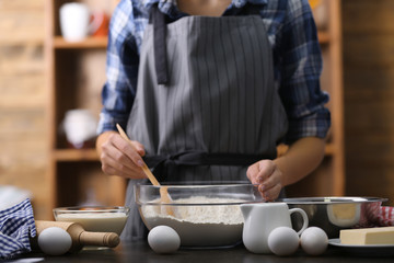 Cooking concept. Woman making dough on kitchen