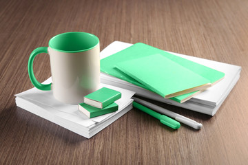 Blank green and white goods on wooden table