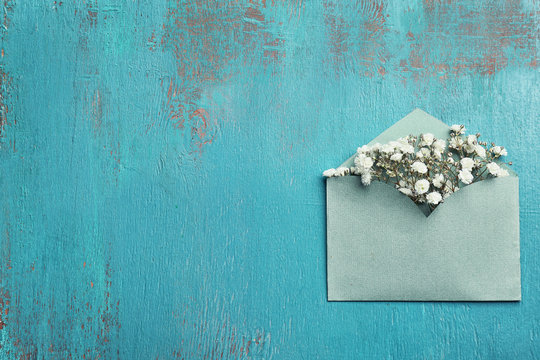 Decorative envelope with beautiful flowers on blue textured background