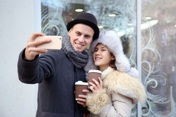 Young couple taking selfie on the street