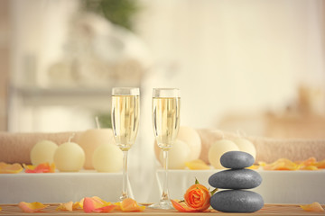 Beautiful spa composition with glasses of champagne on blurred background