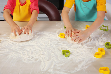 Little children making dough for Easter cookies, closeup