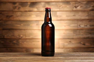 Bottle of beer on wooden background