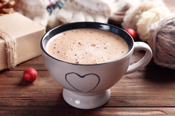 Cup of cocoa and Christmas decoration on wooden background