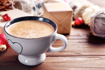 Cup of cocoa and Christmas decoration on wooden background