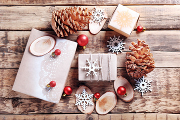 Gift boxes and Christmas decorations on wooden background
