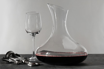 Glass carafe of red wine on gray table