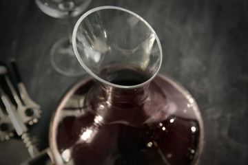 Glass carafe of red wine on gray background