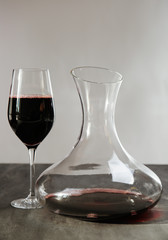 Glass carafe of red wine on gray table
