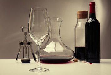 Glass and decanter with bottle on table
