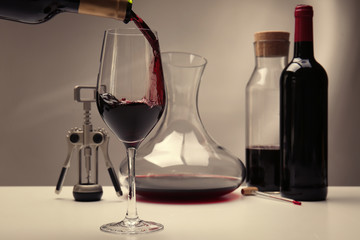Pouring wine in glass on table