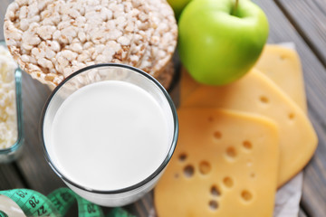 Different dairy products on wooden background