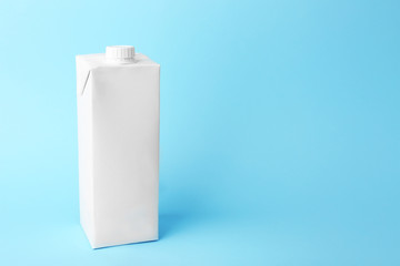 Simple milk box on color background