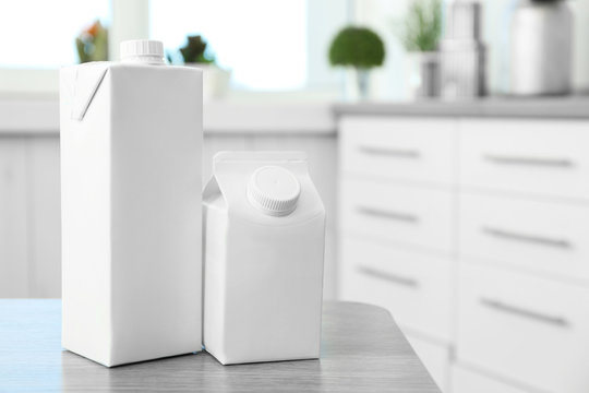 Two simple milk boxes on table in kitchen