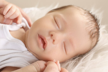 Cute sleeping baby with mother at home, closeup