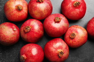 Whole pomegranates on gray background
