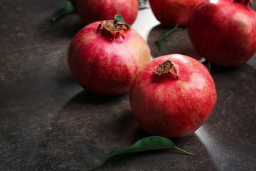 Whole pomegranates on gray background