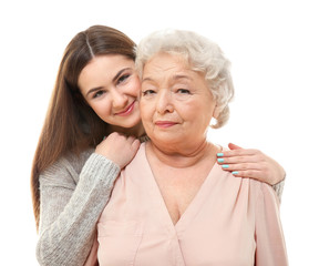 Beautiful girl with grandmother on white background