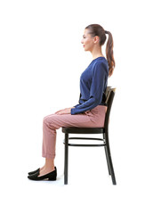 Incorrect posture concept. Young woman sitting on chair against white background