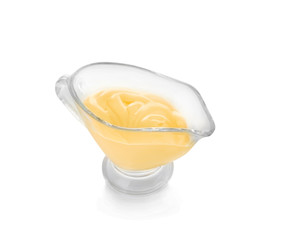 Sauceboat full of creamy cheese, isolated on white