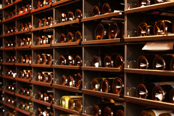 Shelving with wine bottles in winery shop
