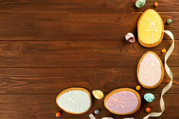 Creative Easter sugar cookies on brown wooden background