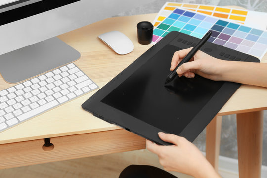 Young designer drawing sketches on graphic tablet