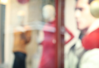 Blurred background of fashion store showcase with mannequins