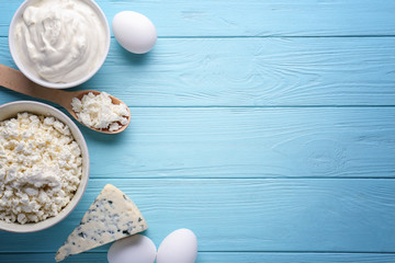 Fresh dairy products on blue wooden background