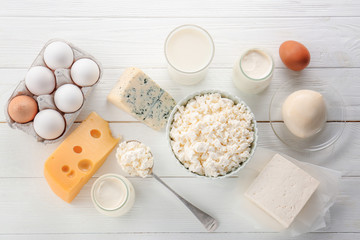 Assortment of natural dairy products on white wooden table