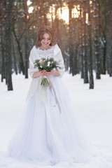Fototapeta na wymiar Beautiful bride with bouquet outdoors on winter day