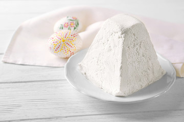 Plate with traditional Easter curd dessert on table
