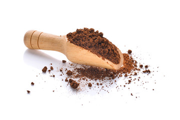 coffee powder in wooden scoop isolated on white background