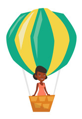 Woman flying in hot air balloon.