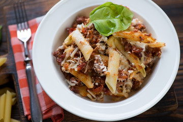 Close-up of ziti casserole served in a white glass plate