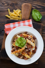 Plate with italian ziti casserole in a rustic wooden setting