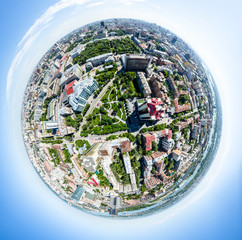 Aerial city view with crossroads, roads, houses, buildings, parks and parking lots. Copter drone helicopter shot. Panoramic wide angle image.