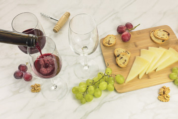 Red wine, cheese, bread and grapes at tasting
