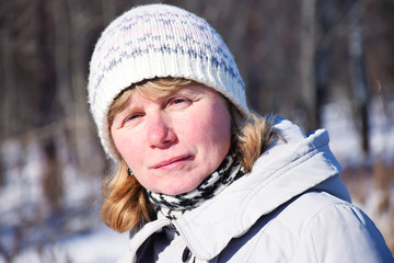 Tranquil mature woman with red nose and white hat