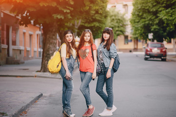 three young girls walking in the park