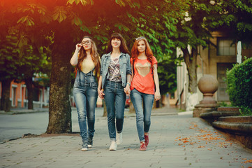 three young girls walking in the park