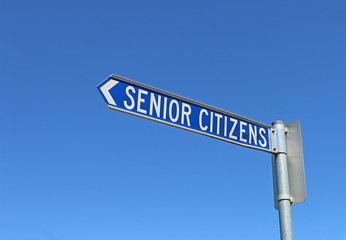 blue and white senior citizens sign in a cloudless blue sky