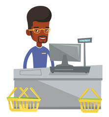 Cashier standing at the checkout in supermarket.