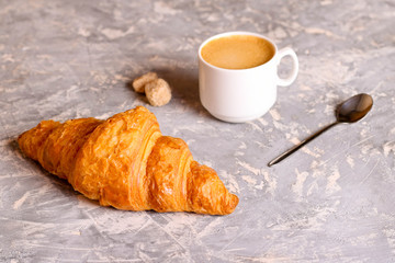 Coffee cup and fresh baked croissants