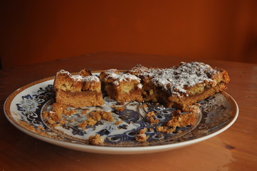 Apple pie dusted with icing sugar on the kitchen table.