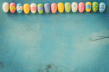 Colorful easter eggs on blue wood background with copy space.