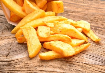 fried potatoes on a wooden background